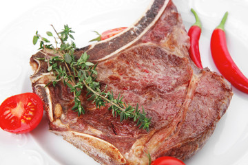 savory : grilled spare rib on white dish with pepper and tomato