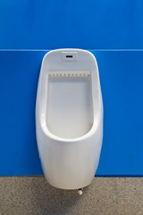 Urinal on blue wall
