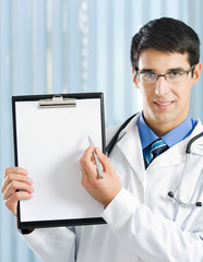 Doctor with clipboard at office
