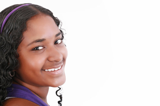 Beautiful smiling face of a happy African teenager girl, isolate