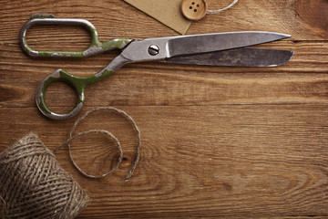 Old scissors and buttons on the wooden table