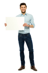 Businessman holding blank poster