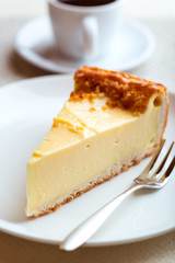 Piece of Cheesecake and Cake Fork on a Plate