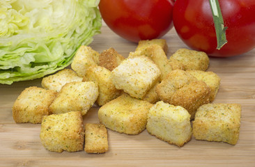 Cheese and garlic croutons on cutting board