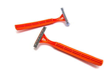 two orange razor blades on white