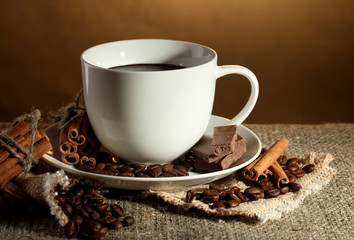 cup of coffee and beans, cinnamon sticks and chocolate