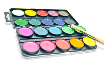 Watercolors and wooden brush on white
