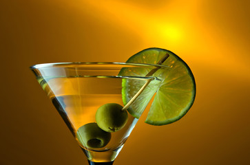 martini with lime and green olives.