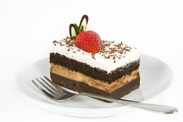 Piece of chocolate cake with strawberry decorate on top