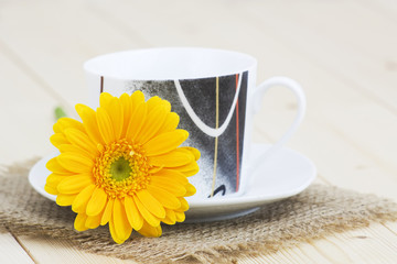 cup of coffee with orange gerbera