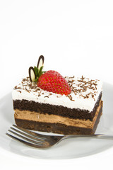 Piece of chocolate cake with strawberry decorate on top