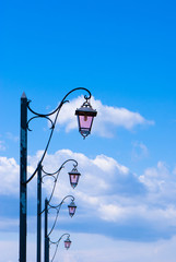 Street lamps against a deep blue sky