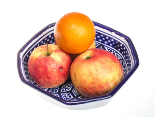 apple on a plate isolated on white background
