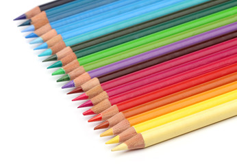 Color pencils over white background