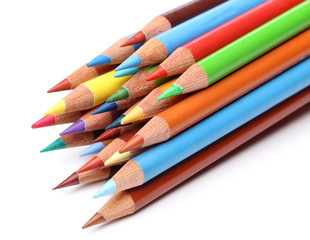 Color pencils over white background