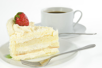 Delicious vanilla cake with strawberry decorate on top and a cup