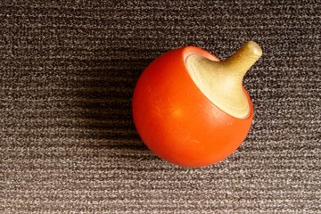 red roud spinning top on textile background