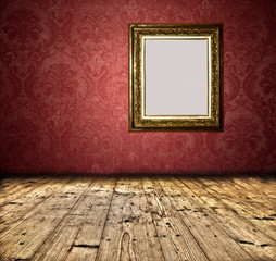 Blank golden frame on grunge wall