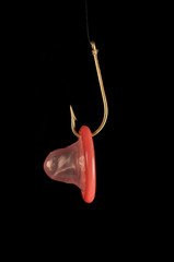 red condom and golden fisfing hook