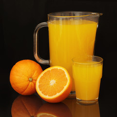 orange fresh fruits and juice in glass