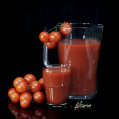 tomatoes, jug and glass full of fresh tomatoes juice