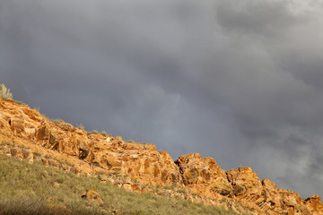 stormy sky over sandstone cliff