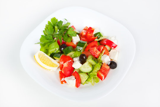 fresh Greek salad in white bowl