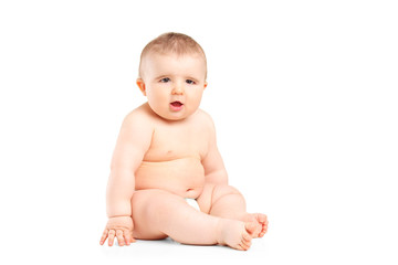 A 9 month old baby in diapers sitting