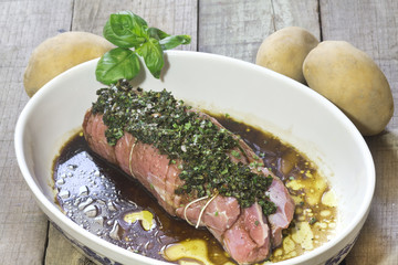 raw calf roast with aromatic herbs, balsamic vinegar and potatoe
