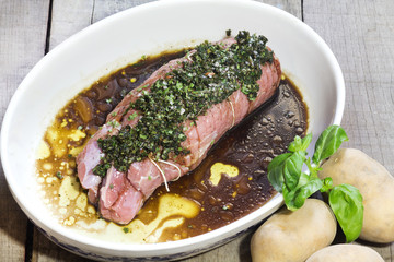 calf roast with aromatic herbs, balsamic vinegar and potatoes