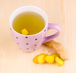 Healthy ginger tea with lemon on wooden background