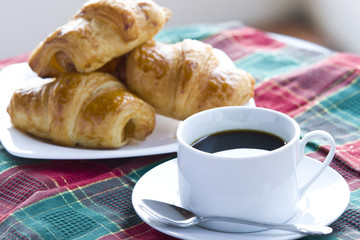Breakfast with a cup of black coffee and croissants, Shallow DOF