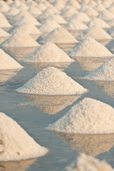Salt fields with piled up sea salt in Thailand