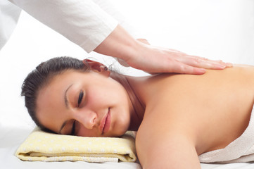 Obraz na płótnie Canvas Beautiful young women getting a massage in massage salon