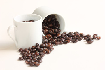 Coffee beans with a white ceramic cup