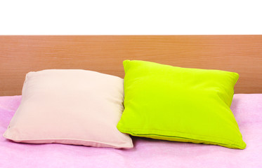 bright pillows on bed on white background