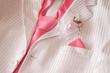 Wedding costume with pink necktie and buttonhole