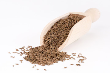 cumin seeds in wooden spoon