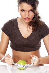Young dietician with apple and measuring tape
