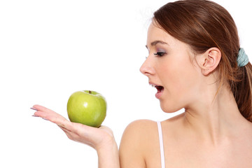 Obraz na płótnie Canvas A smiling girl with green apple, on white