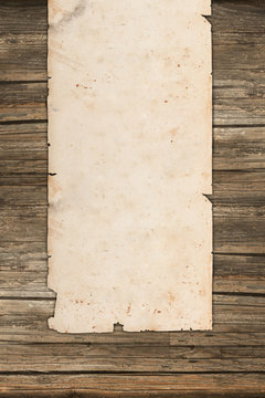 Old paper roll on a vintage wooden background