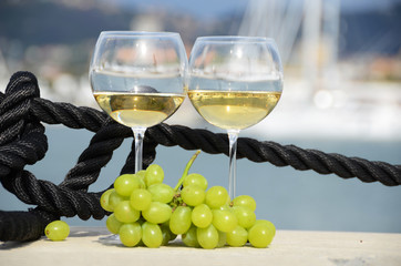 Wineglasses and grapes on the pier