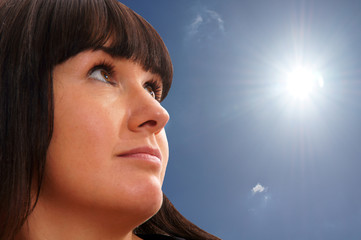 Portrait of a young woman who looks to the sun