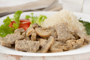 pork with mushrooms, boiled rice and salad