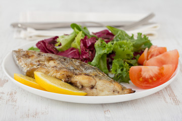 grilled swordfish with salad on the plate