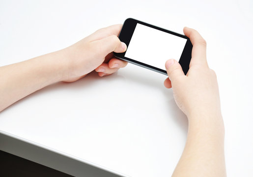 Two hands with smartphone on white table