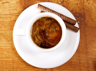 Cup of coffee with milk and cookies