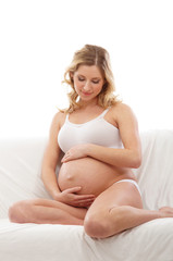 Fototapeta na wymiar A young and happy blond pregnant Caucasian woman