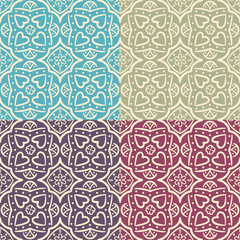 Seamless ornate backgrounds with hearts in four colors