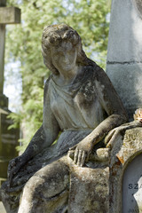 Fototapeta na wymiar Old cemetery angel sculpture made of stone